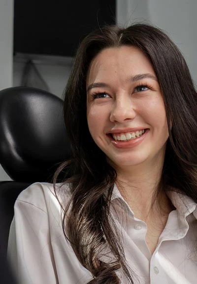 woman smiling after visiting Mitten Family Dental