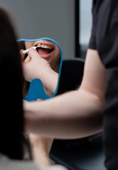 patient looking in the mirror at Mitten Family Dental