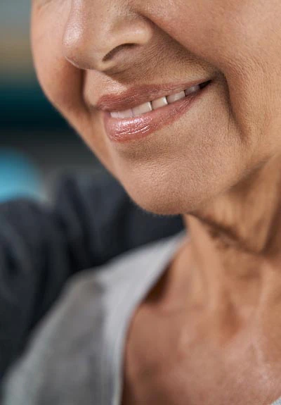 woman smiling with dental implants from Mitten Family Dental