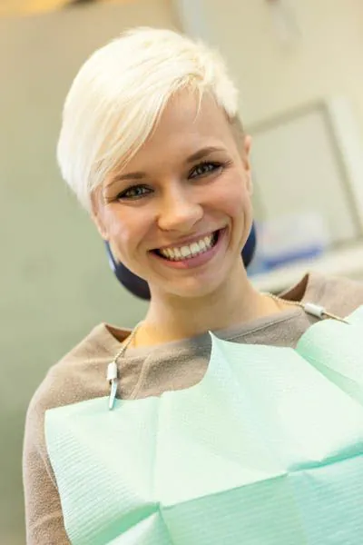 woman smiling during her visit to Mitten Family Dental