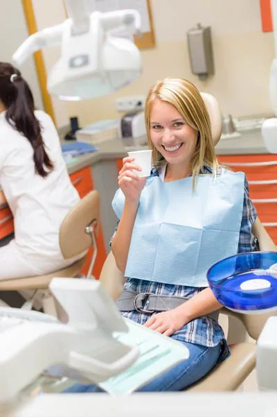 woman smiling while visiting Mitten Family Dental