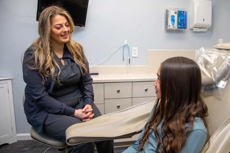 young woman getting dental care at Mitten Family Dental
