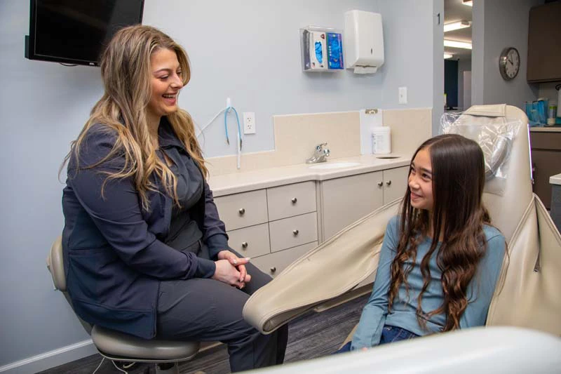 young female patient smiling during her dental appointment at Mitten Family Dental