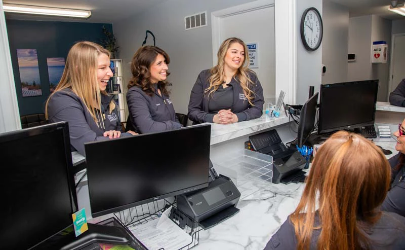 woman smiling during her visit to Mitten Family Dental