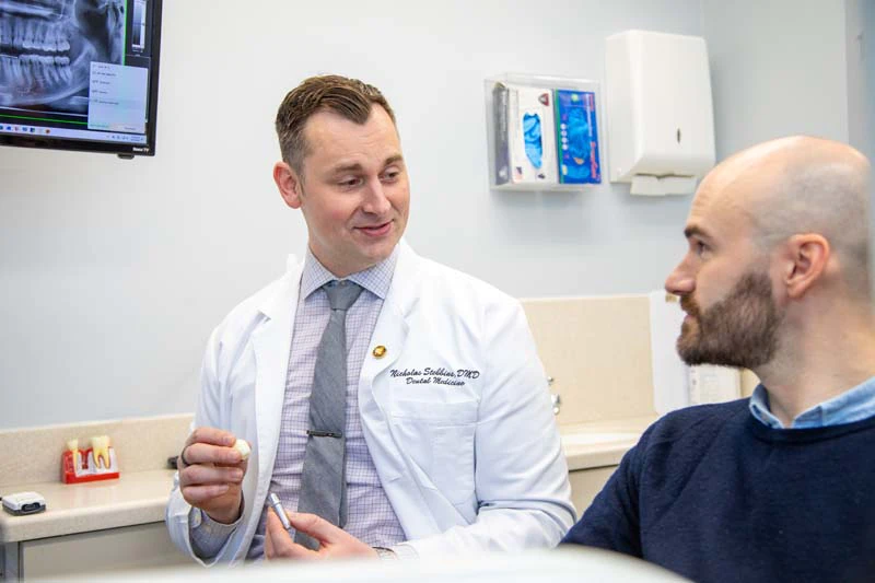 male patient smiling while visiting Mitten Family Dental