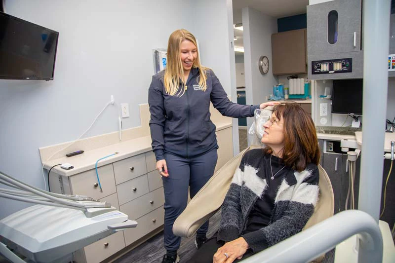 Young patient smiling during her appointment at Mitten Family Dental